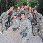 L’équipe Care Concierge pose avec les équipements à la fin de la partie de paintball